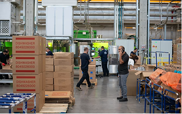 Warehouse staff recording work against labelled stock