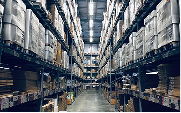 Long warehouse aisle lined with racked inventory