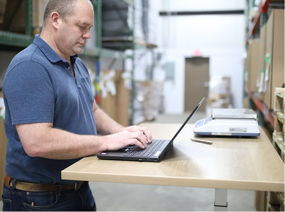 A payroll reviewer working through a timesheet approval period on a laptop