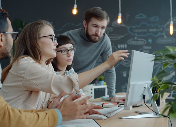 Team walking through a rollout plan at a workstation